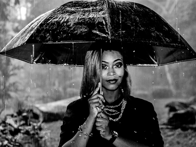 Woman under the rain with umbrella