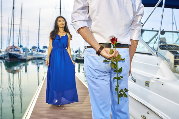 A man waiting to give a rose to his girlfriend.