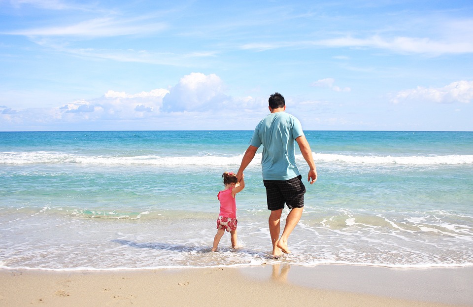Girl and father at the beach